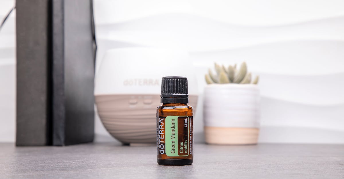 green mandarin essential oil bottle in a modern setting with a diffuser and books